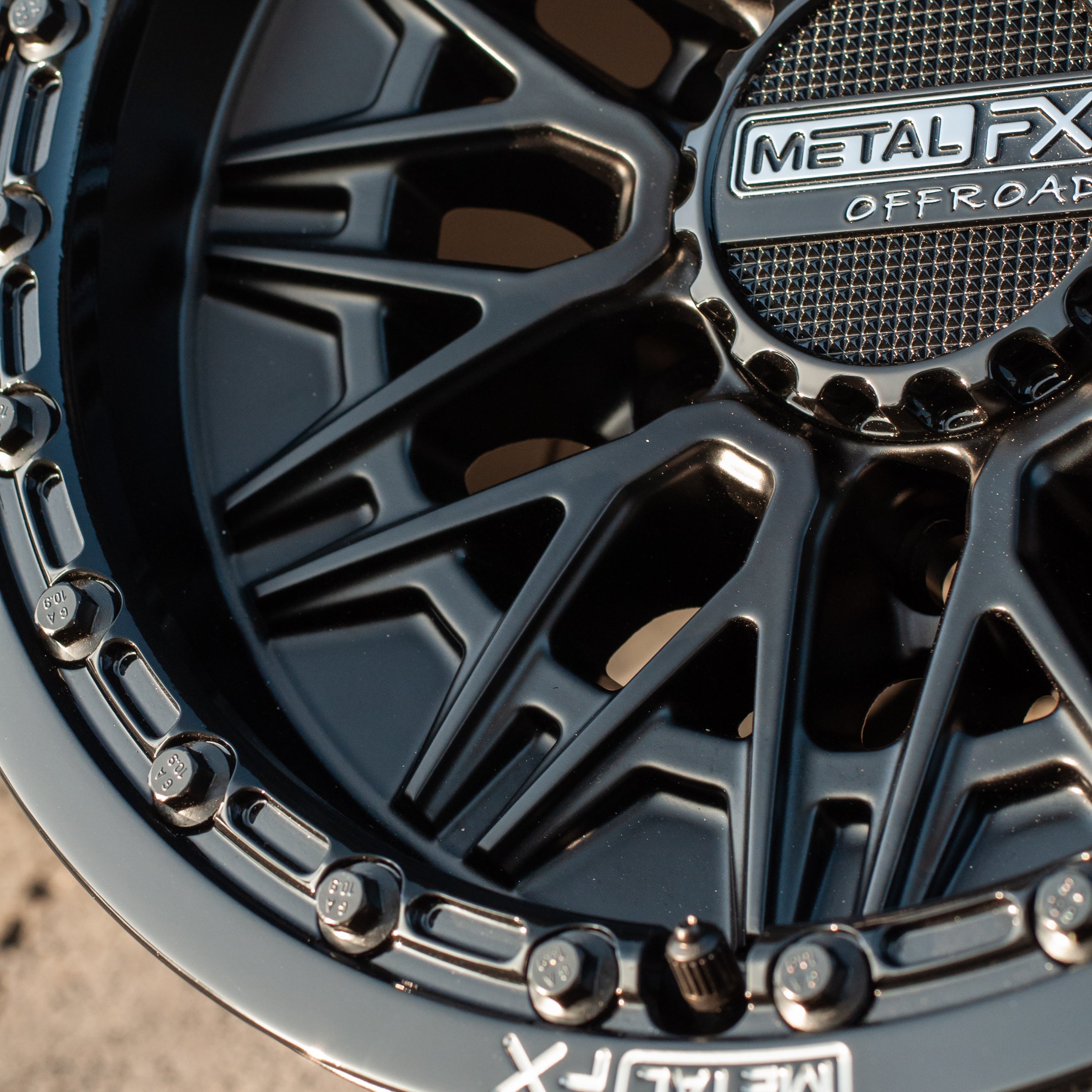 Close-up of Alpha 6R beadlock wheels featuring satin black finish and gloss black ring from Metal FX Offroad.