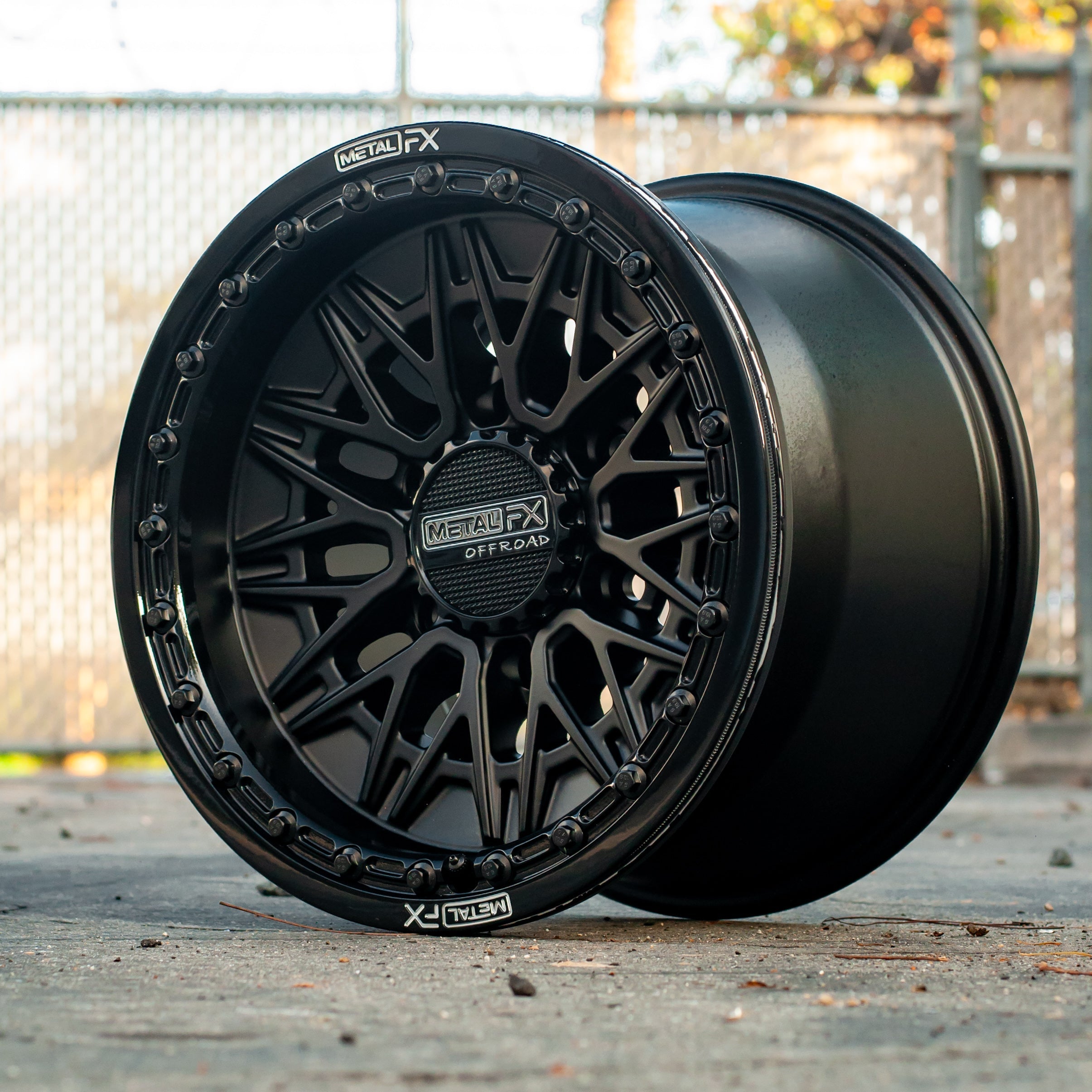 Alpha 6R beadlock wheels featuring a satin black finish with a gloss black ring on a clear background.